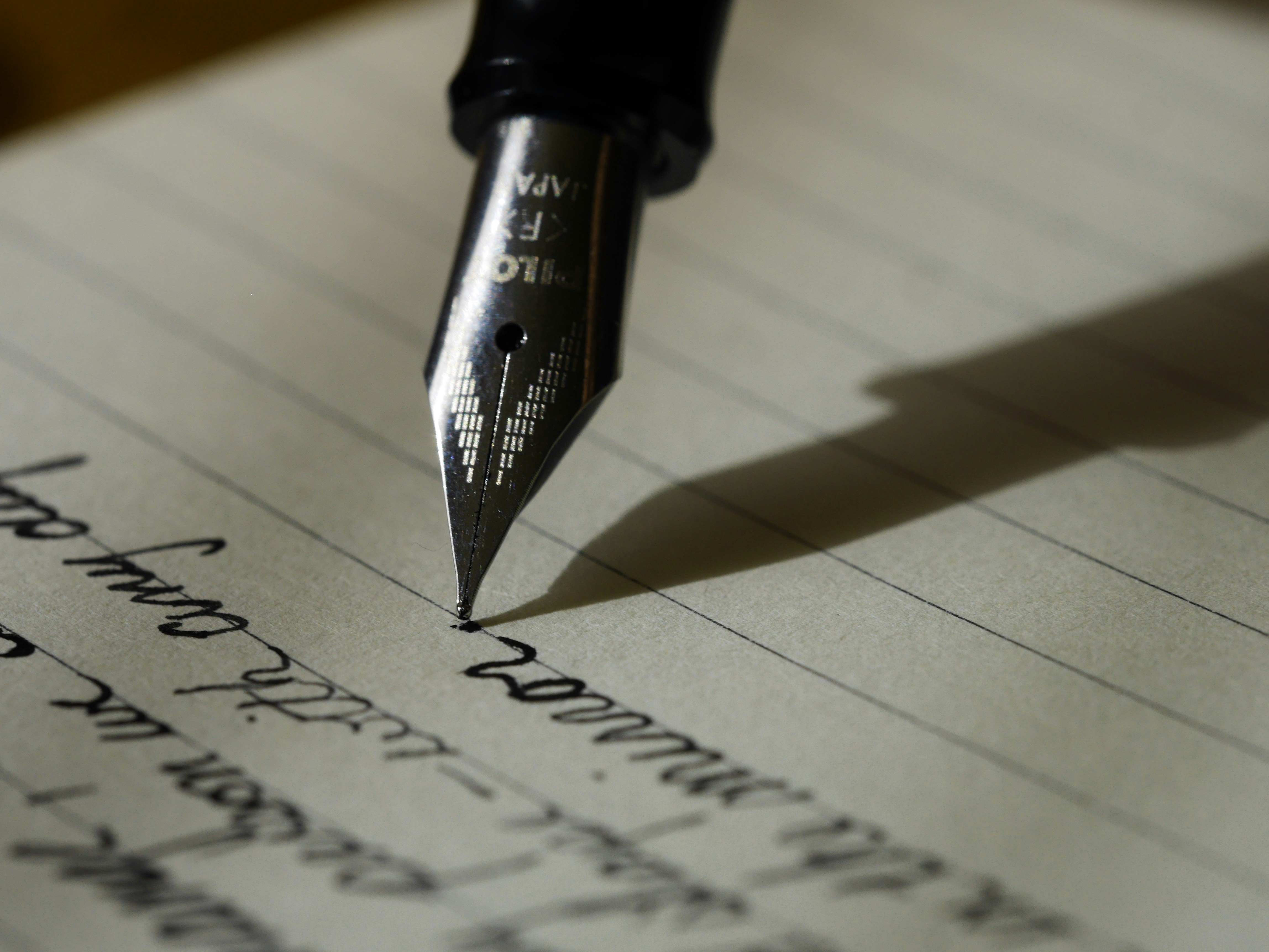 a pen writing on paper